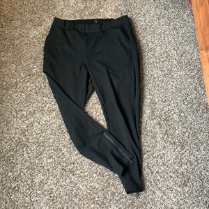 Universal Standard black skinny pants with ankle zipper.